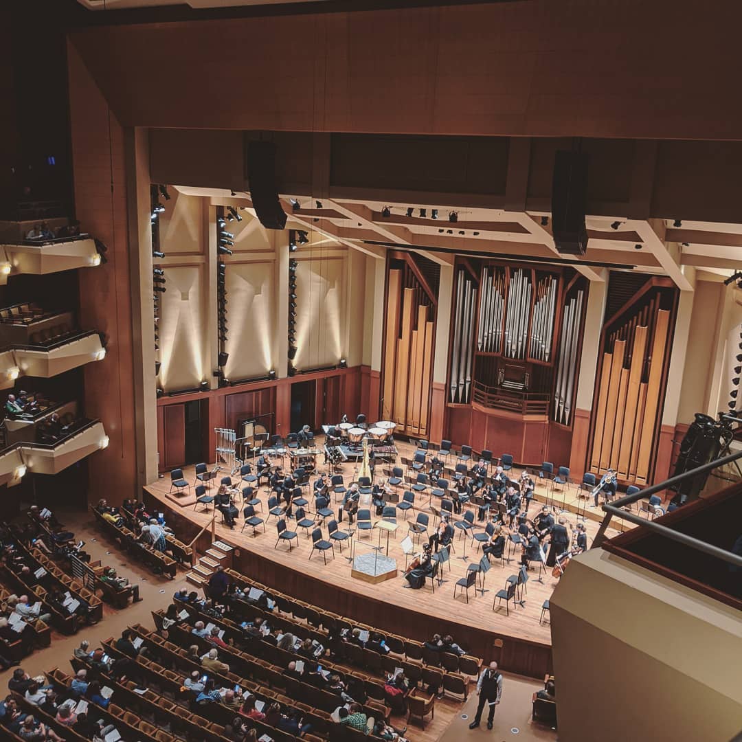 Orchestra warming up on stage.